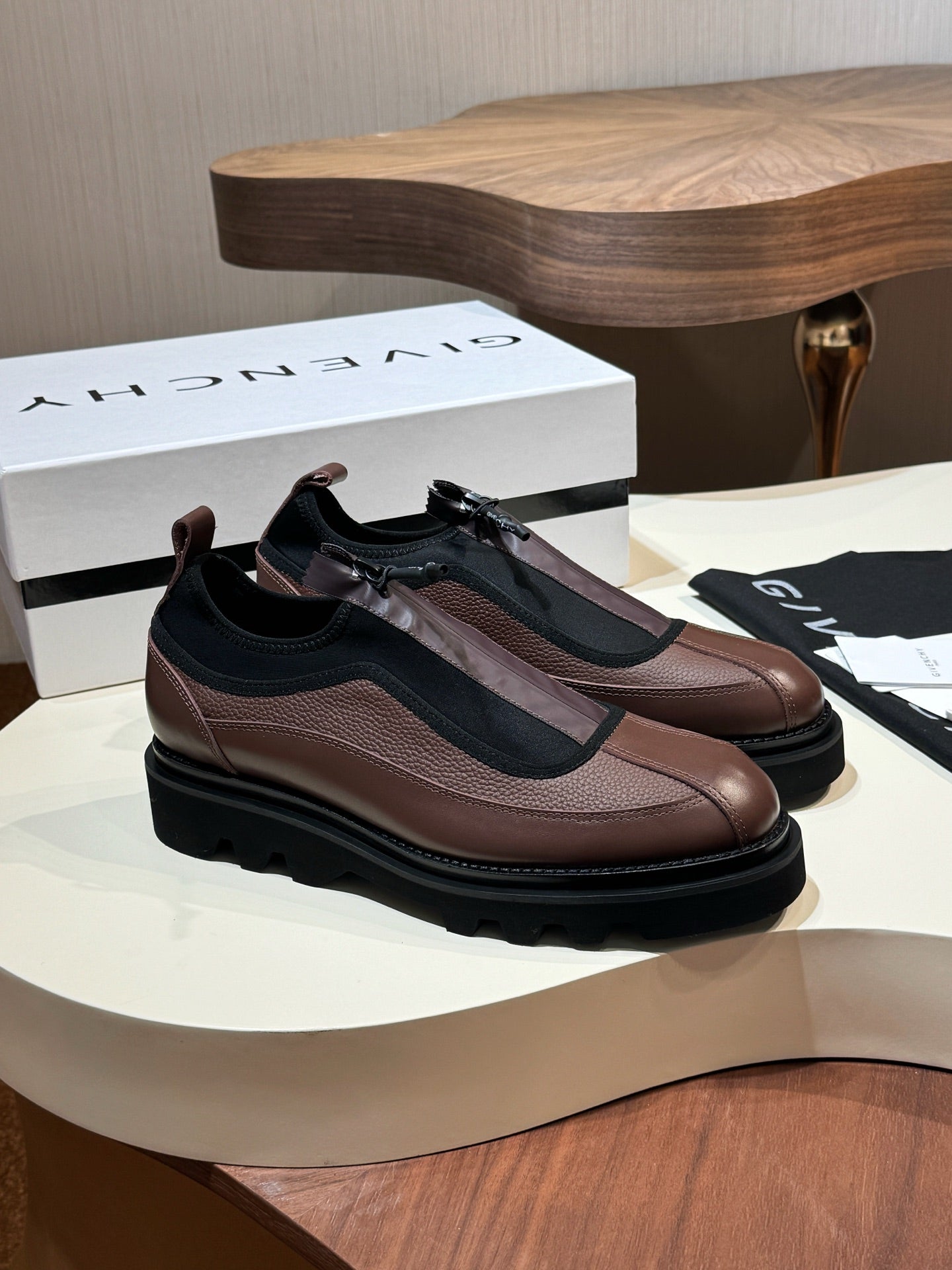 Givenchy lace-up leather shoes with brown upper, black side panels, and chunky sole.