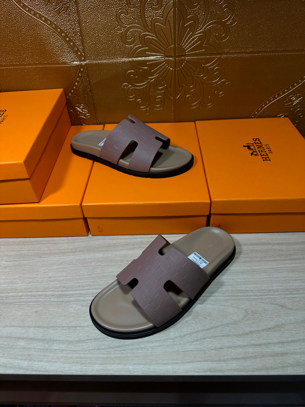 Hermes slide sandals on orange boxes, lilac straps and black sole