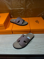 Hermes slide sandals on orange boxes, lilac straps and black sole