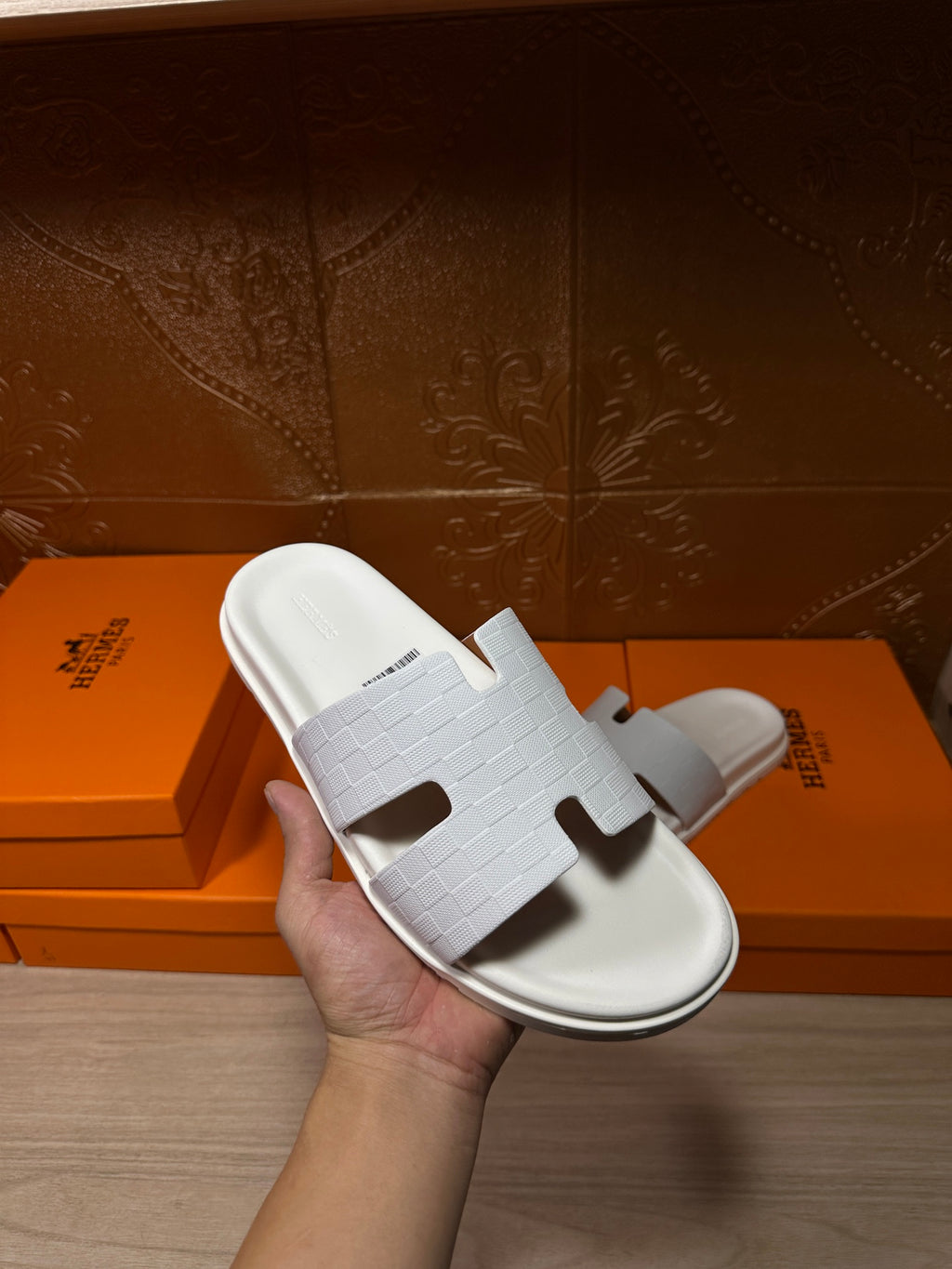 Hermes white slide sandal with textured strap and cutout H-style front detail