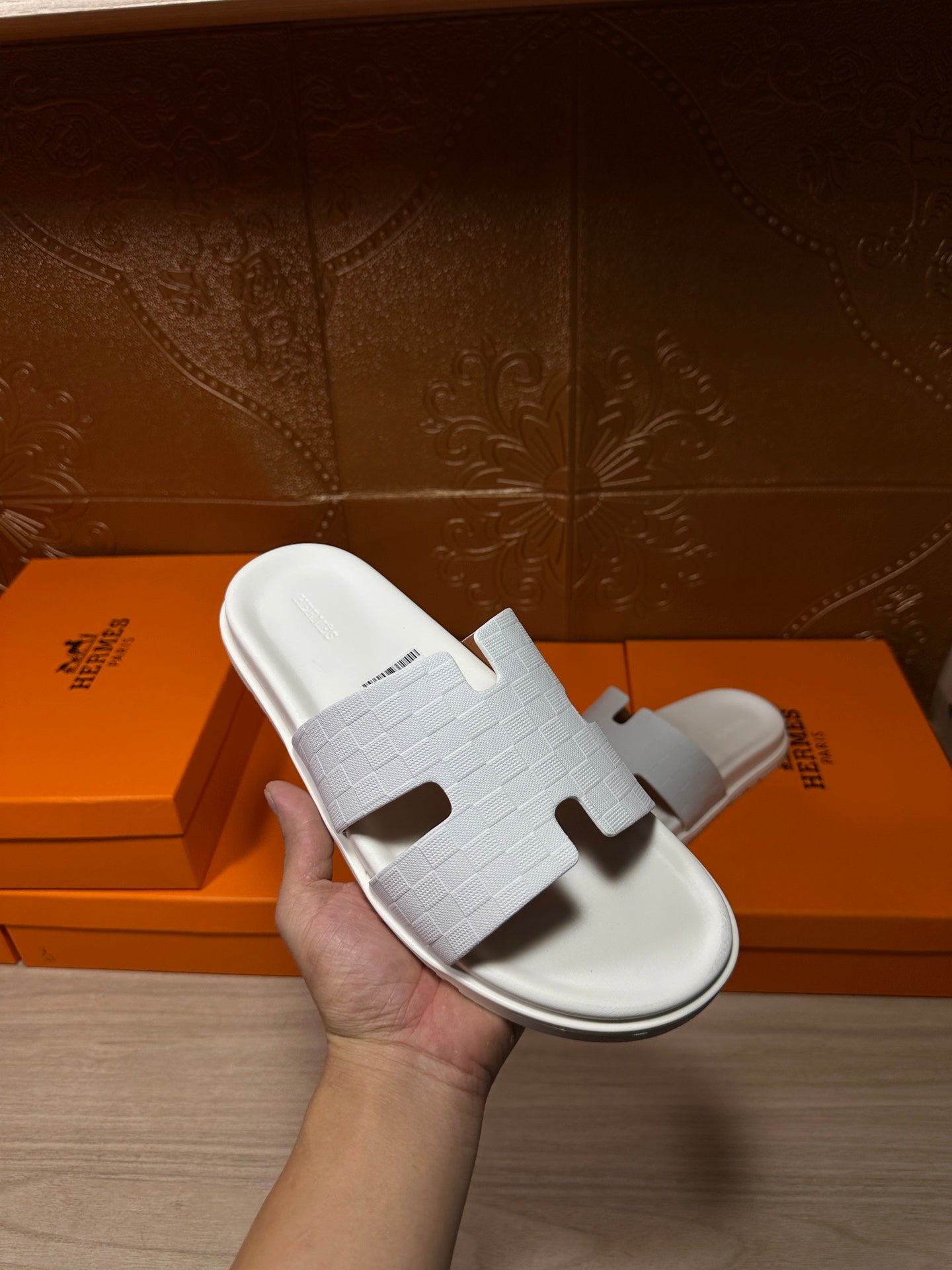 Hermes white slide sandal with textured strap and cutout H-style front detail