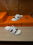 Hermes white slide sandals with textured strap and cutout H-style detail