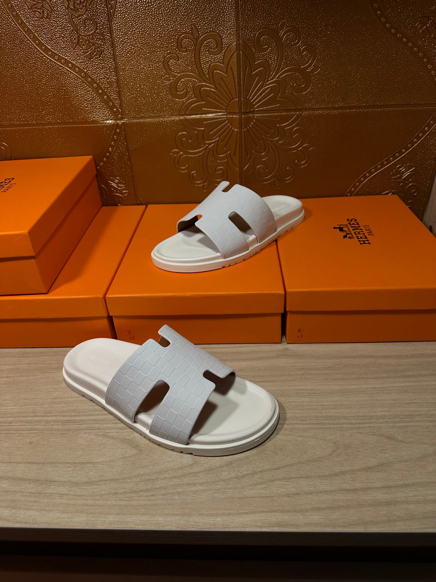 Hermes white slide sandals with textured strap and cutout H-style detail