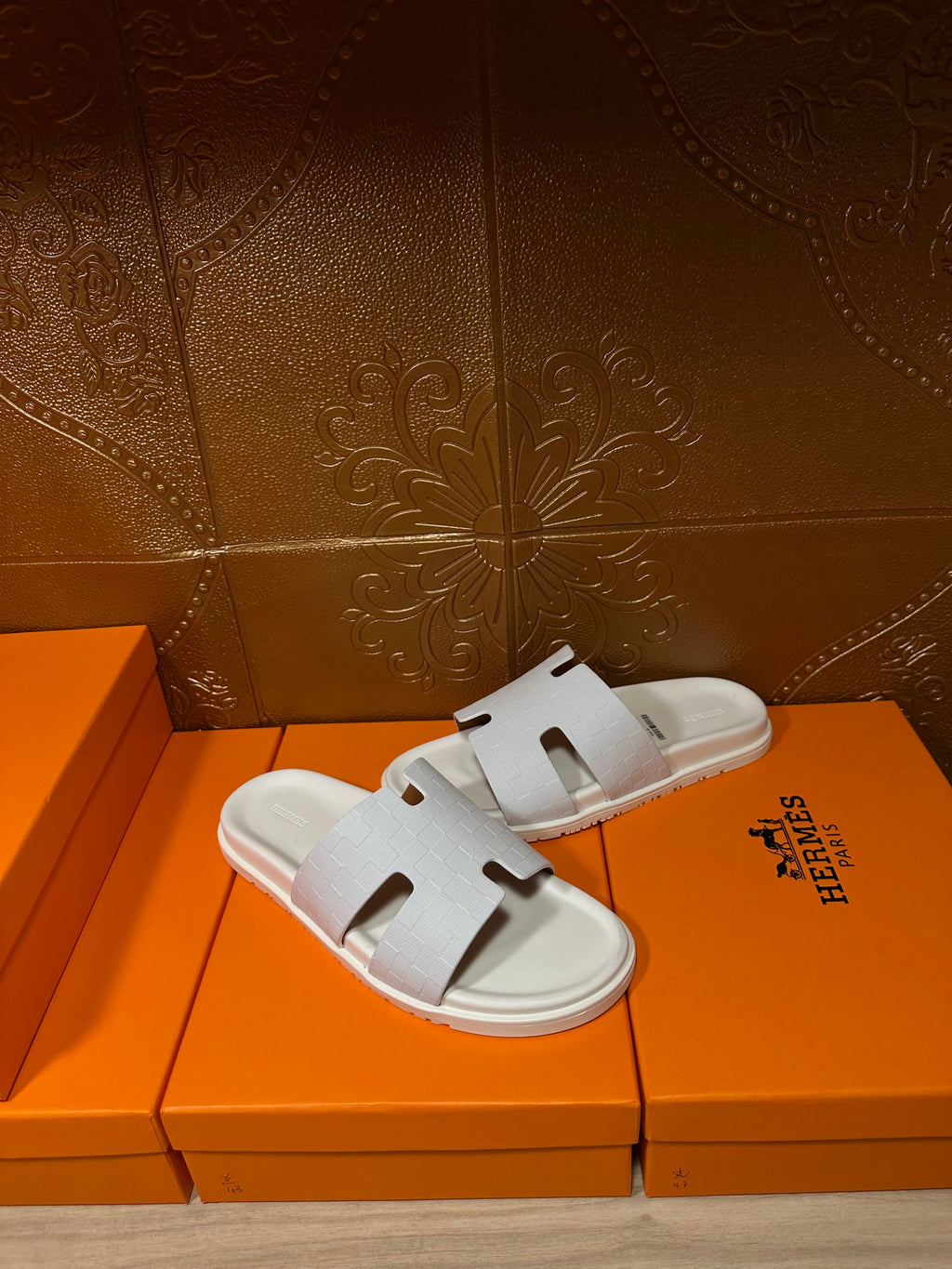 Hermes white slide sandals with smooth straps and cutout H-style detail