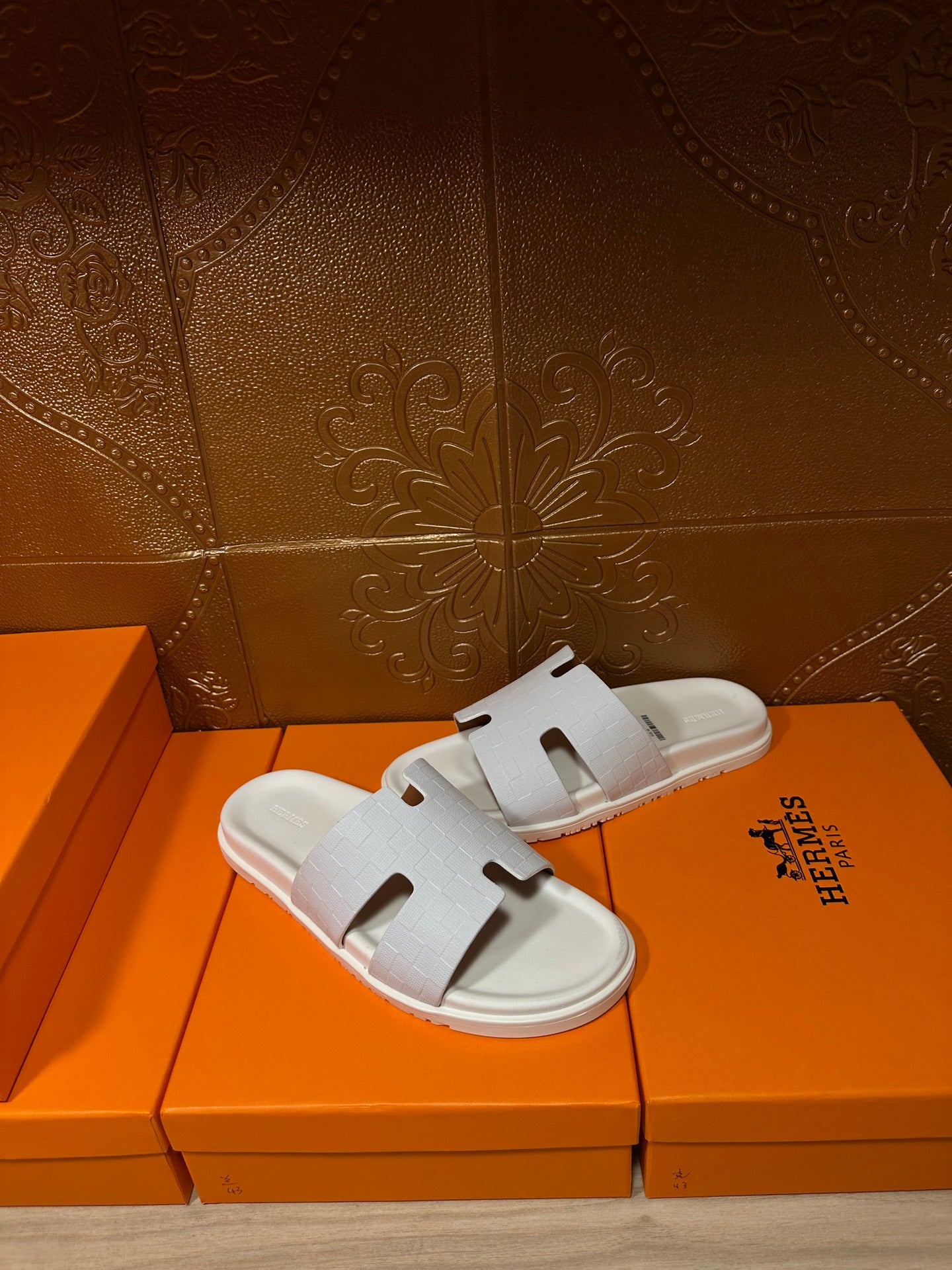 Hermes white slide sandals with smooth straps and cutout H-style detail