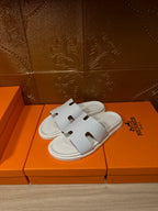Hermes white slide sandals, crossover straps with cutout H-style detail