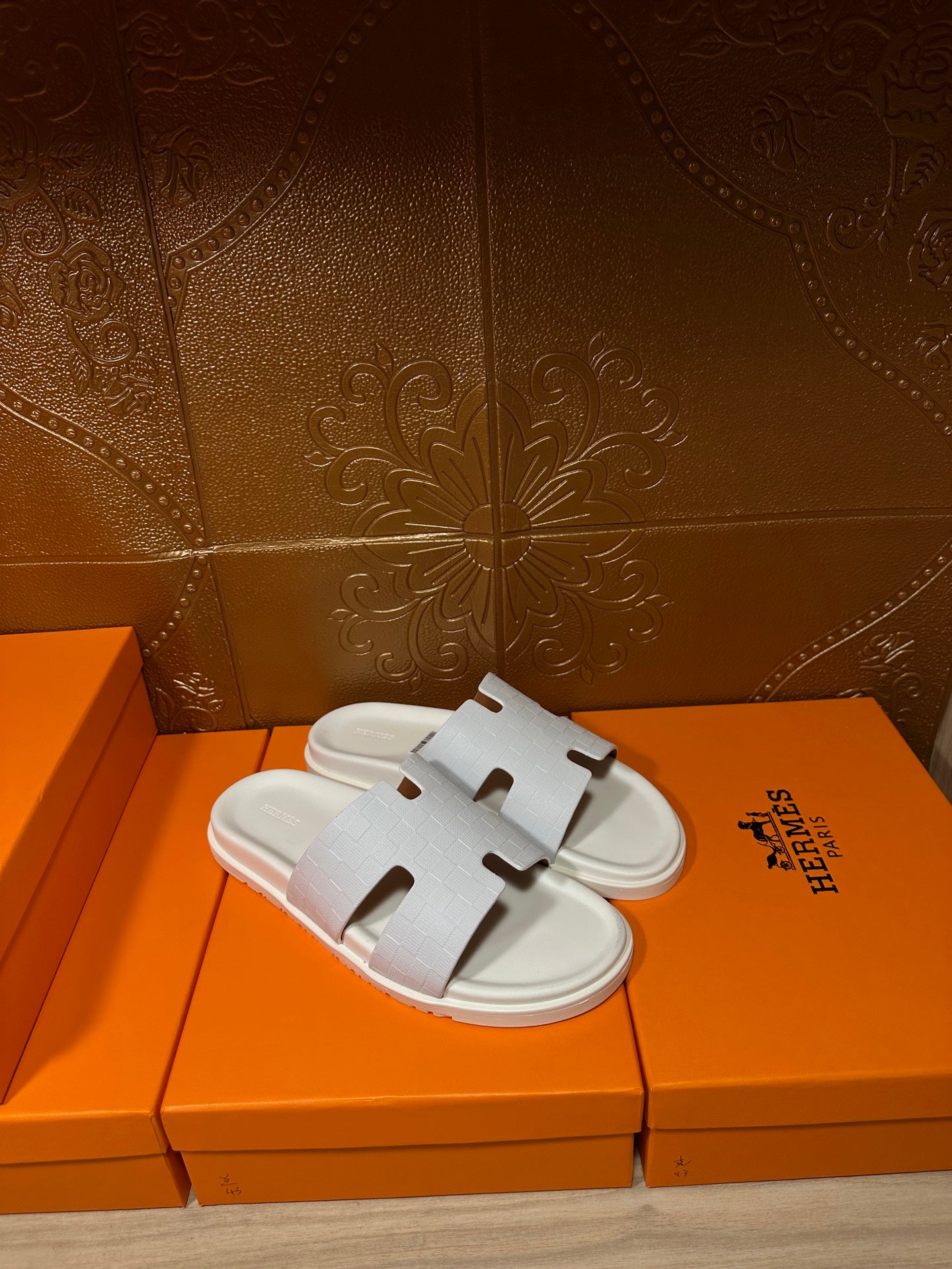 Hermes white slide sandals with smooth straps and open toe, side view