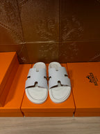 Hermes white slide sandals with smooth crossover straps and wide open toe