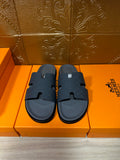 Dark blue slide sandals with textured cross-strap and contoured footbed