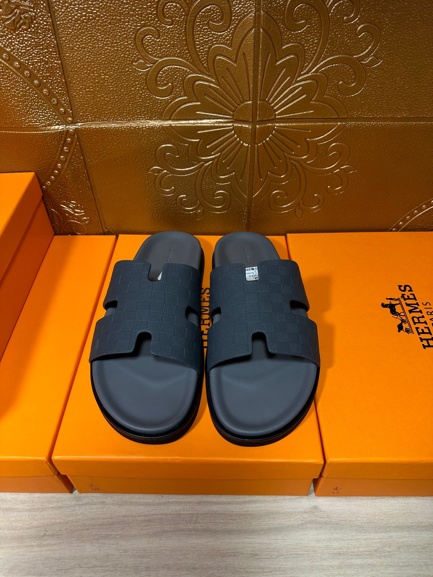Dark blue slide sandals with textured cross-strap and contoured footbed