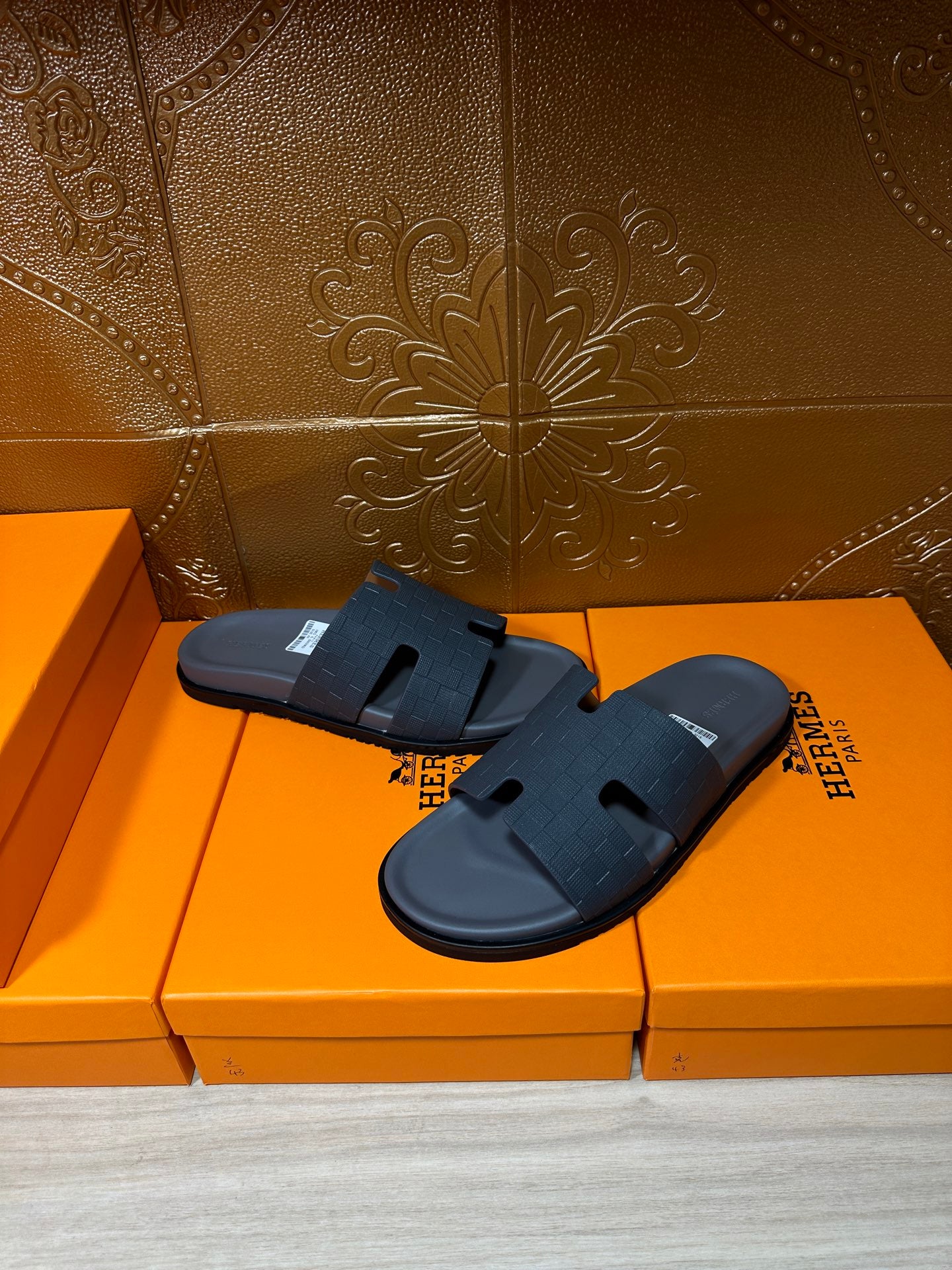 Dark blue slide sandals on orange boxes, textured band and open toe