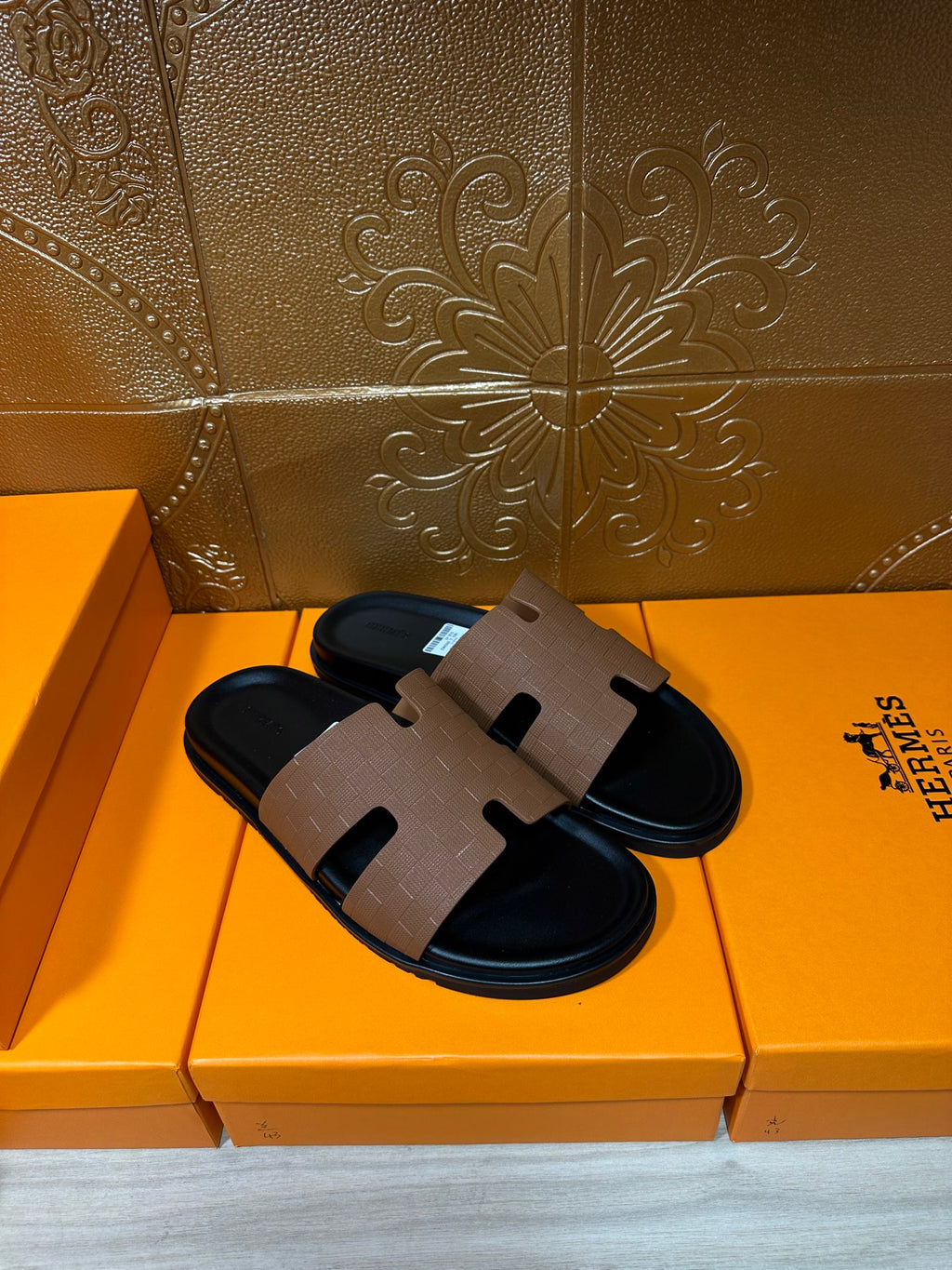 Hermes slide sandals with tan leather band and black sole, top view