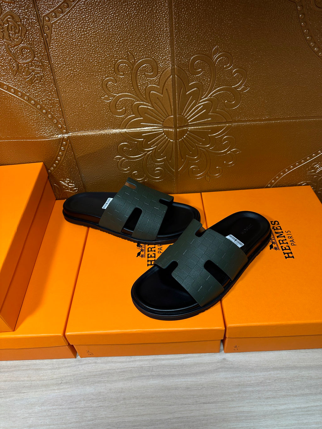 Hermes black slide sandals on boxes, crossed strap detail with flat rubber base