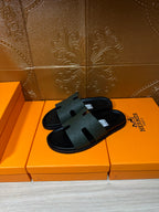 Hermes black slide sandals, single pair view with wide textured foot strap