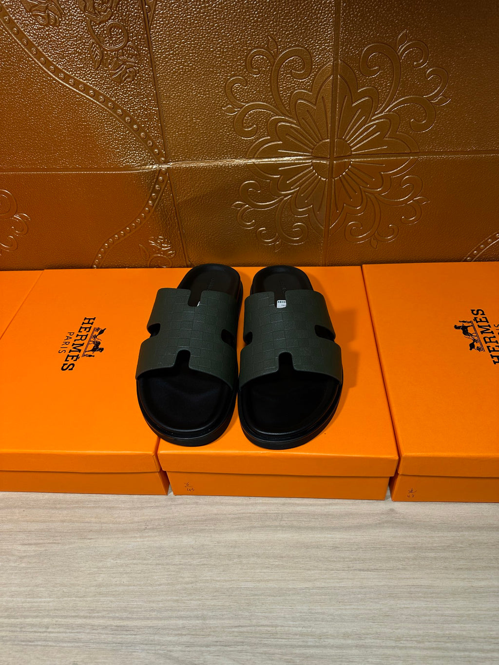 Hermes black slide sandals with wide textured strap and flat rubber sole