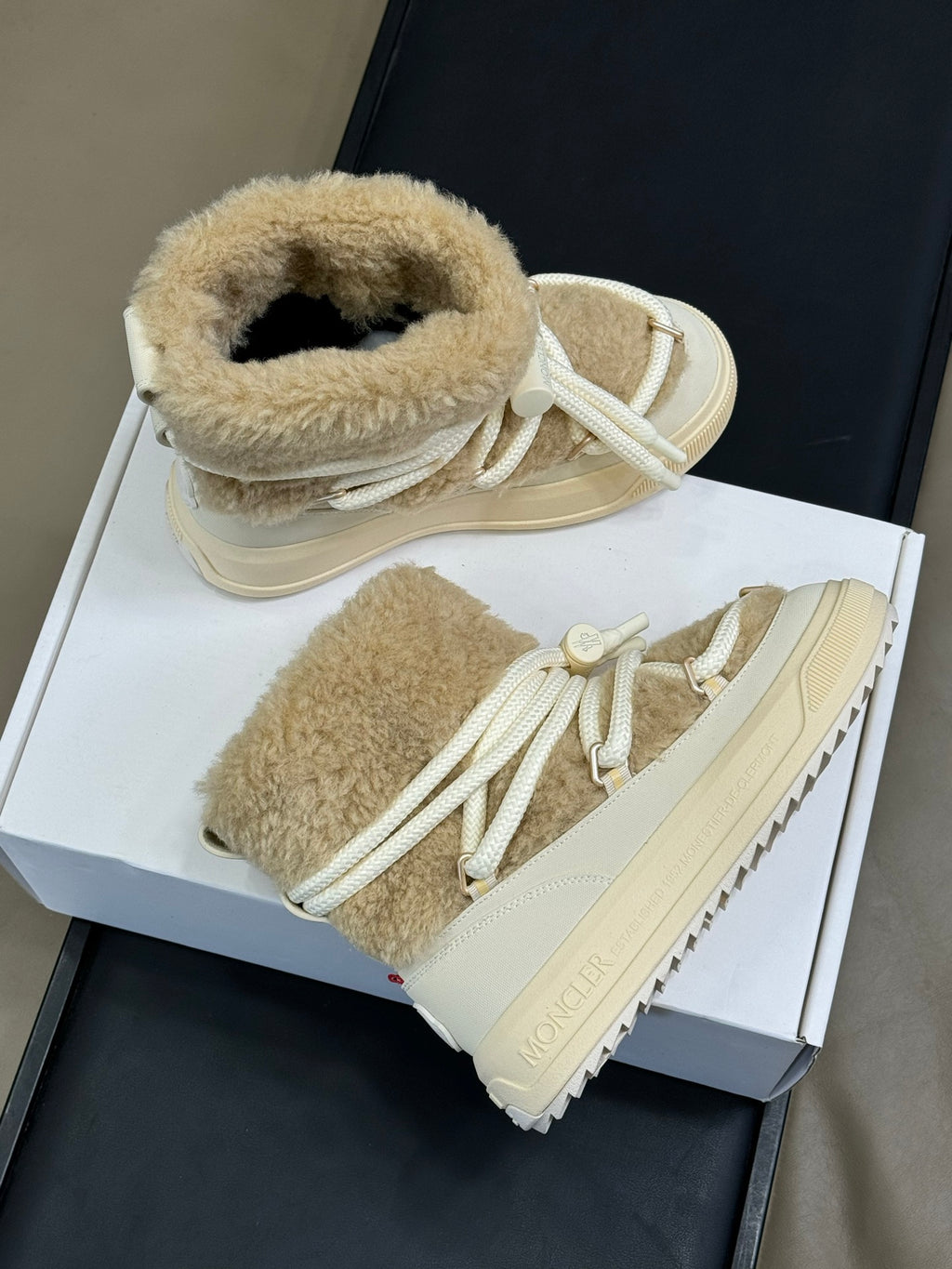 Moncler shearling lace-up boots in light tan with padded collars and rubber lug sole