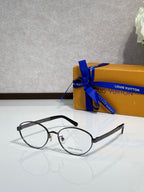 Black round eyeglasses with clear lenses and silver-tone details