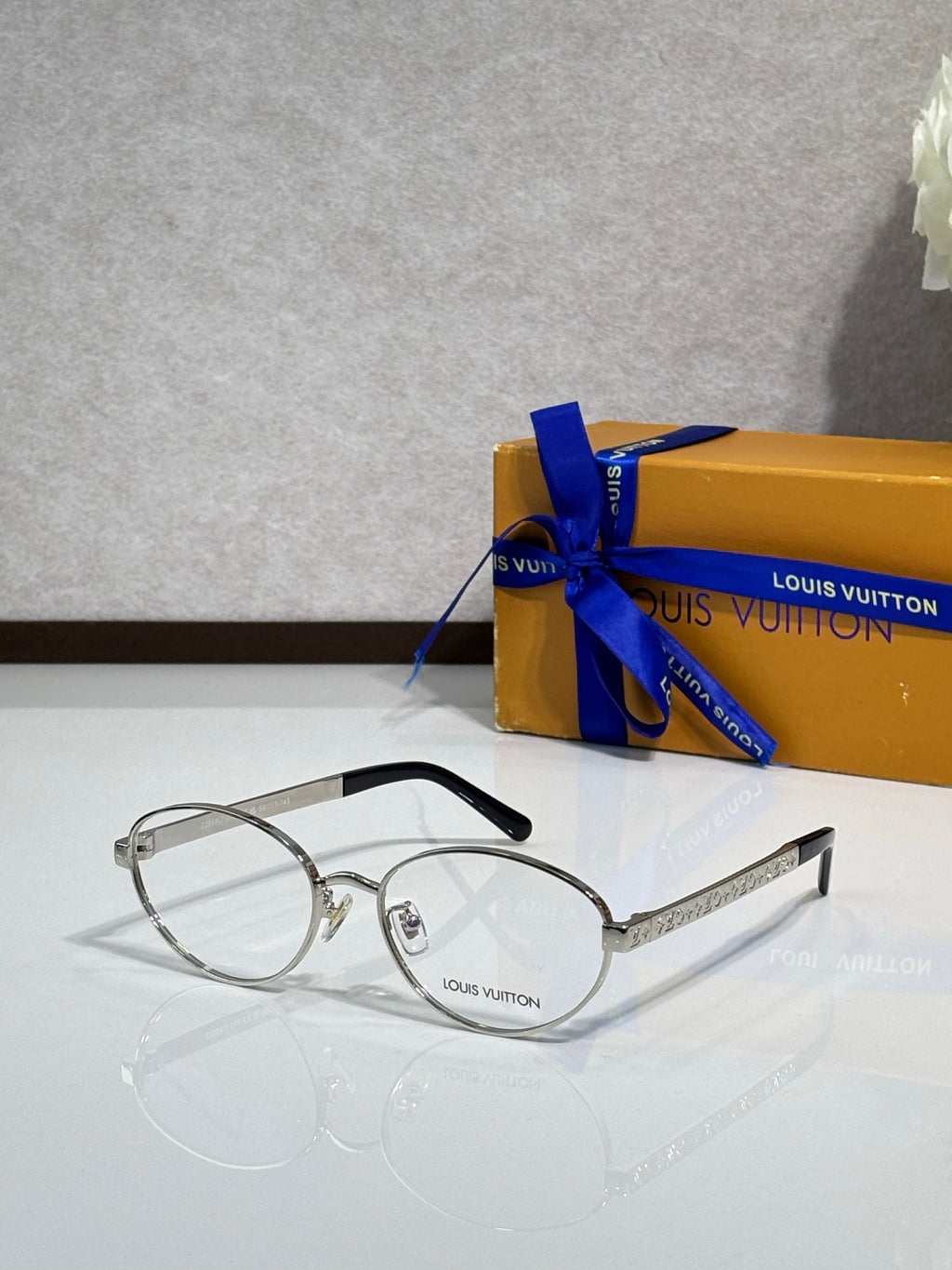 Silver round eyeglasses with clear lenses and thin black temple tips