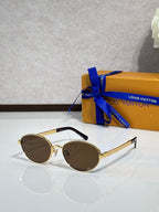 Gold round sunglasses with brown-tinted lenses and black temple tips