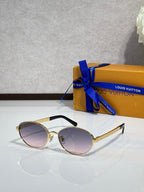 Gold round sunglasses with purple-tinted lenses and black temple tips