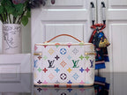 Louis Vuitton monogram vanity bag with multicolor icons, top zip, and gold clasp