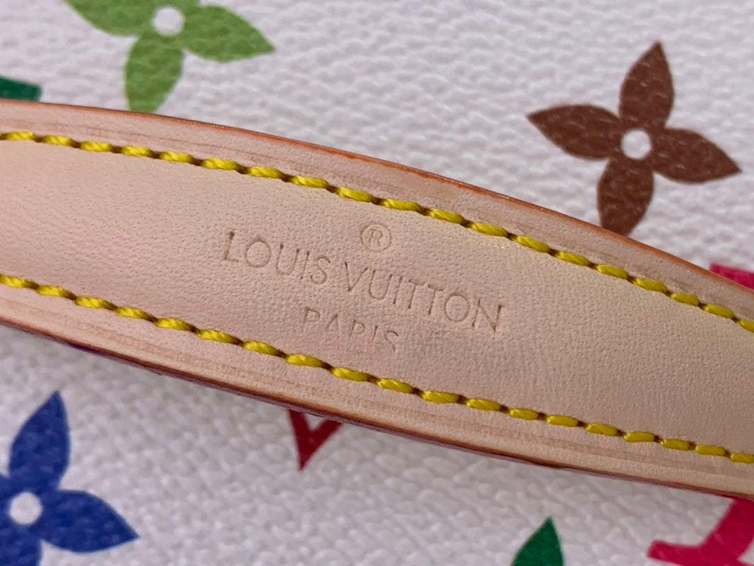 Louis Vuitton monogram bag strap detail with embossed branding and yellow stitching