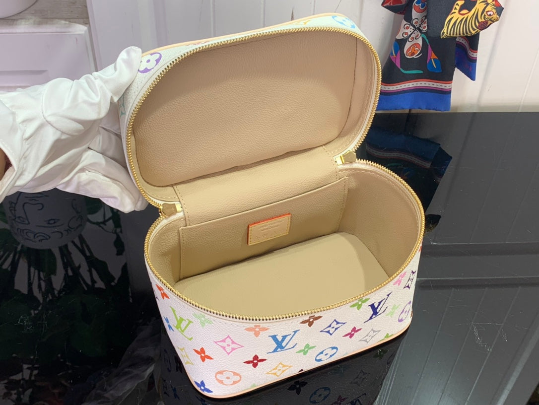 Louis Vuitton vanity bag open with light beige interior and gold zipper trim
