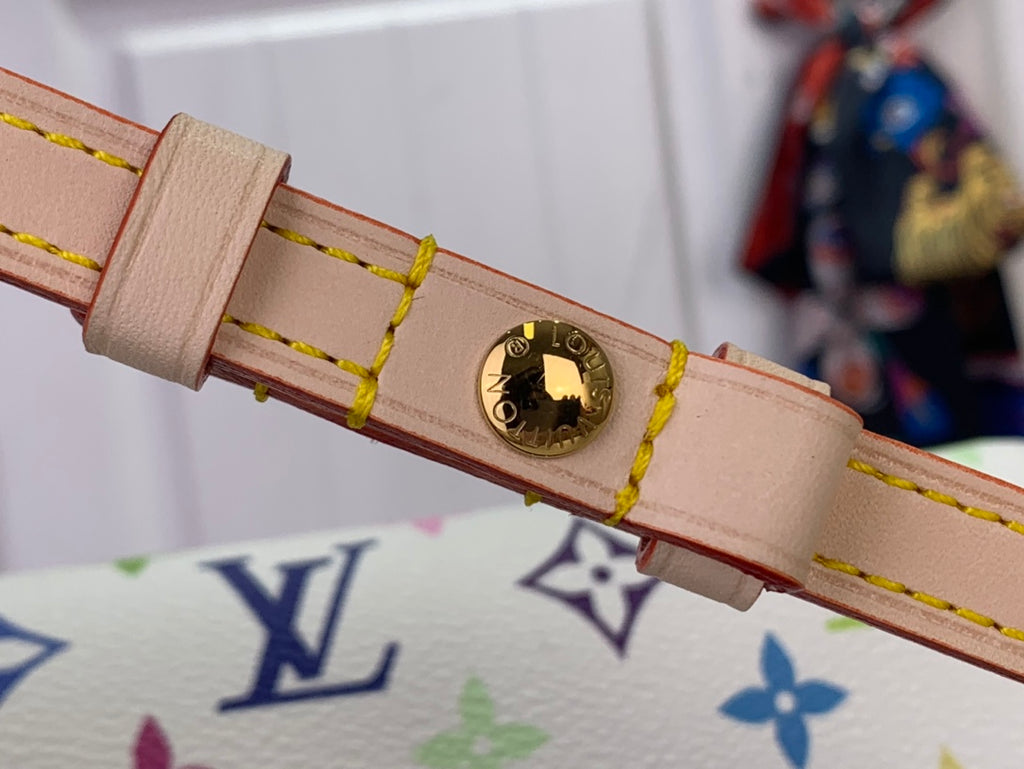 Beige leather strap with stitched edges and round gold-tone hardware on crossbody bag