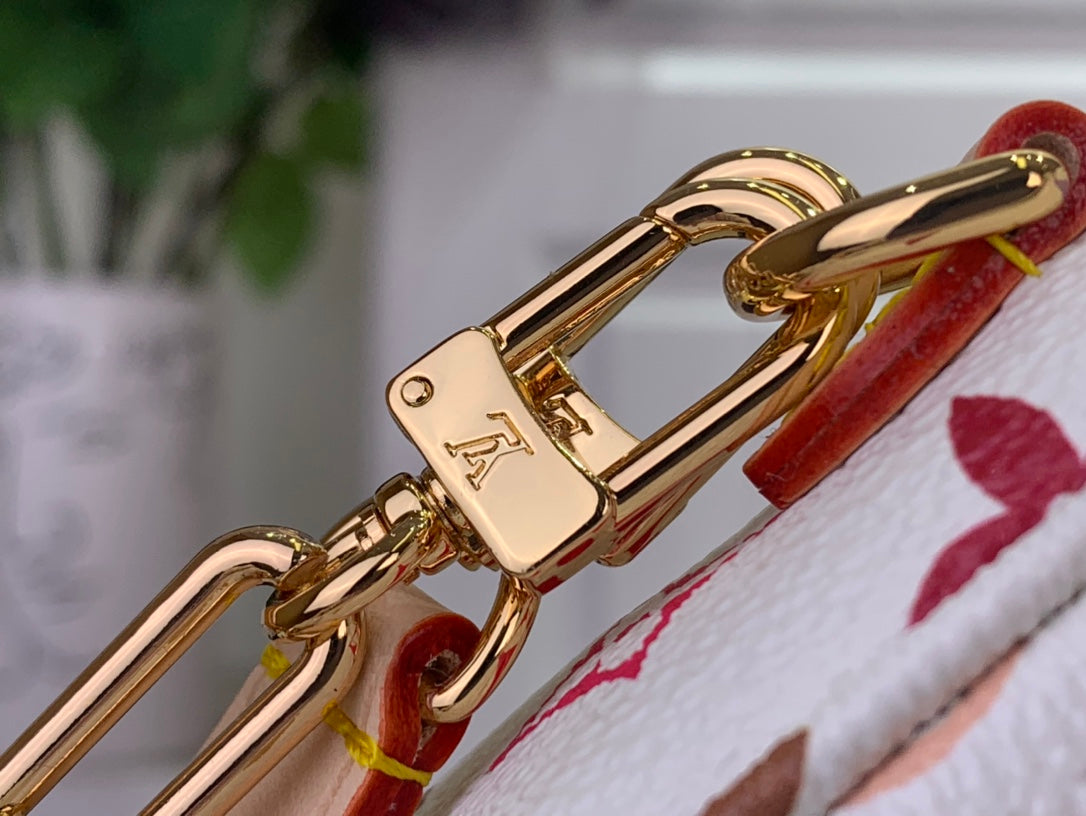Gold-tone clasp and ring hardware on multicolor monogram crossbody bag strap