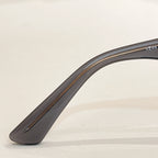 Clear gray sunglasses temple with metallic logo mark
