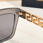 Gold logo hinge detail on clear gray sunglasses frame