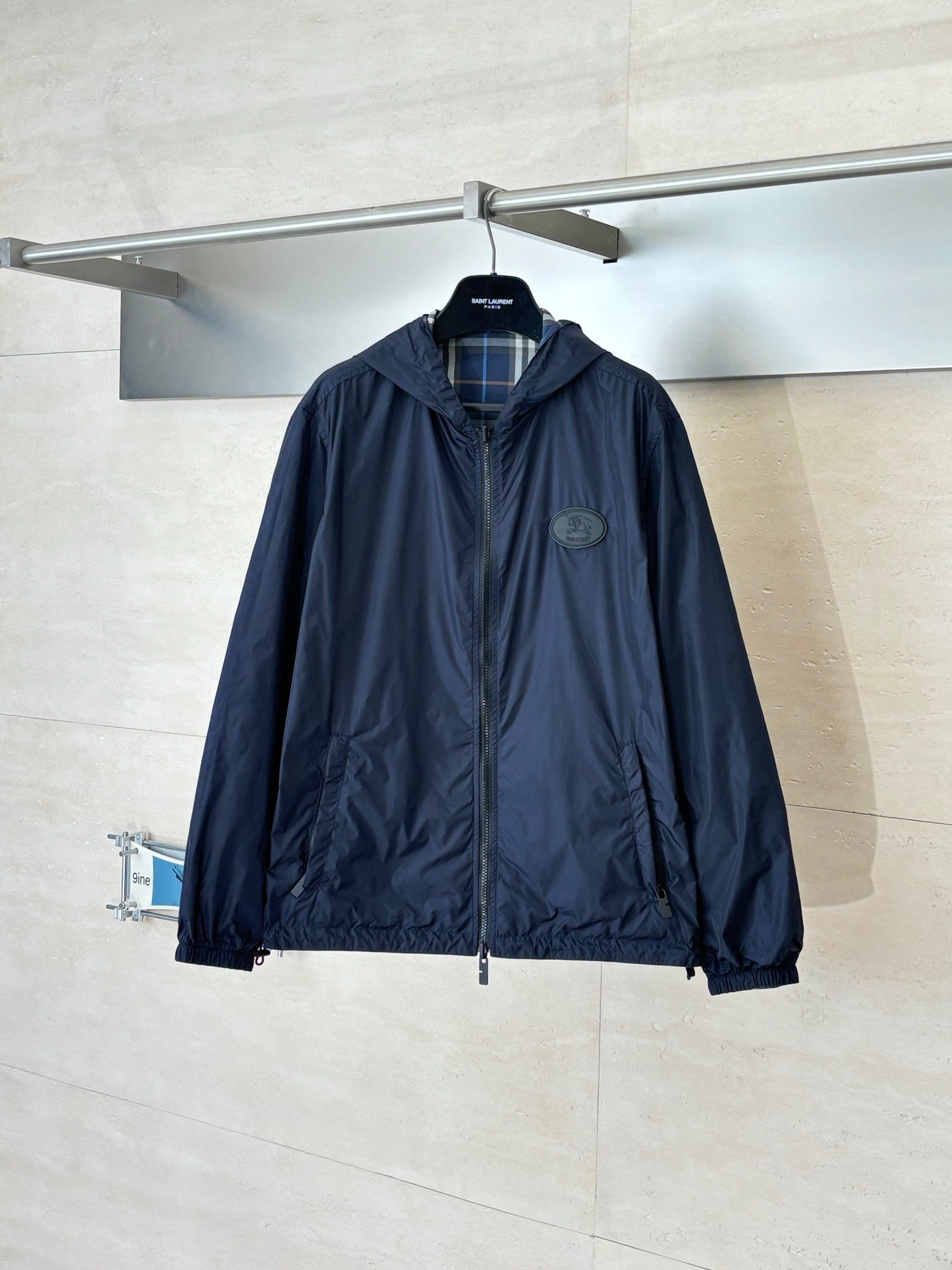 Burberry navy hooded jacket with full zip and subtle chest logo patch