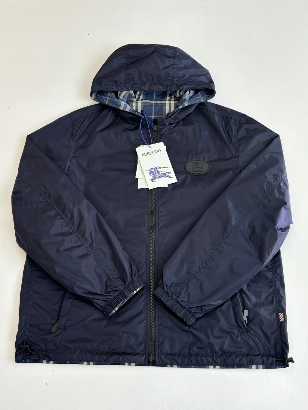 Burberry navy hooded jacket with full zip and round logo patch on chest