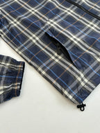 Burberry blue plaid sleeve and cuff close-up with zipper and snap detail