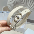 Light leather belt with silver oval buckle and central crystal on a curved strap