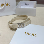 Light leather belt with silver oval buckle and crystal charm, shown on a box