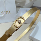 Dior gold-tone belt buckle close-up with oval frame and small rhinestone cluster