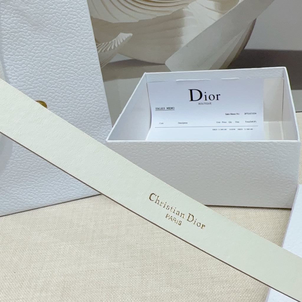 Light gold belt strap with brand text on smooth leather