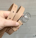 Tan leather belt with silver buckle and round jeweled center