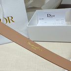 Tan leather belt with Christian Dior embossed script on the strap