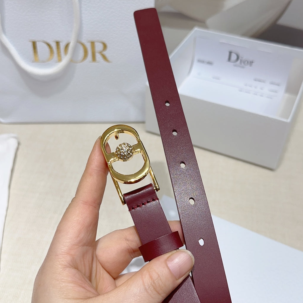 Burgundy leather belt strap with punched holes and gold-tone buckle with crystal