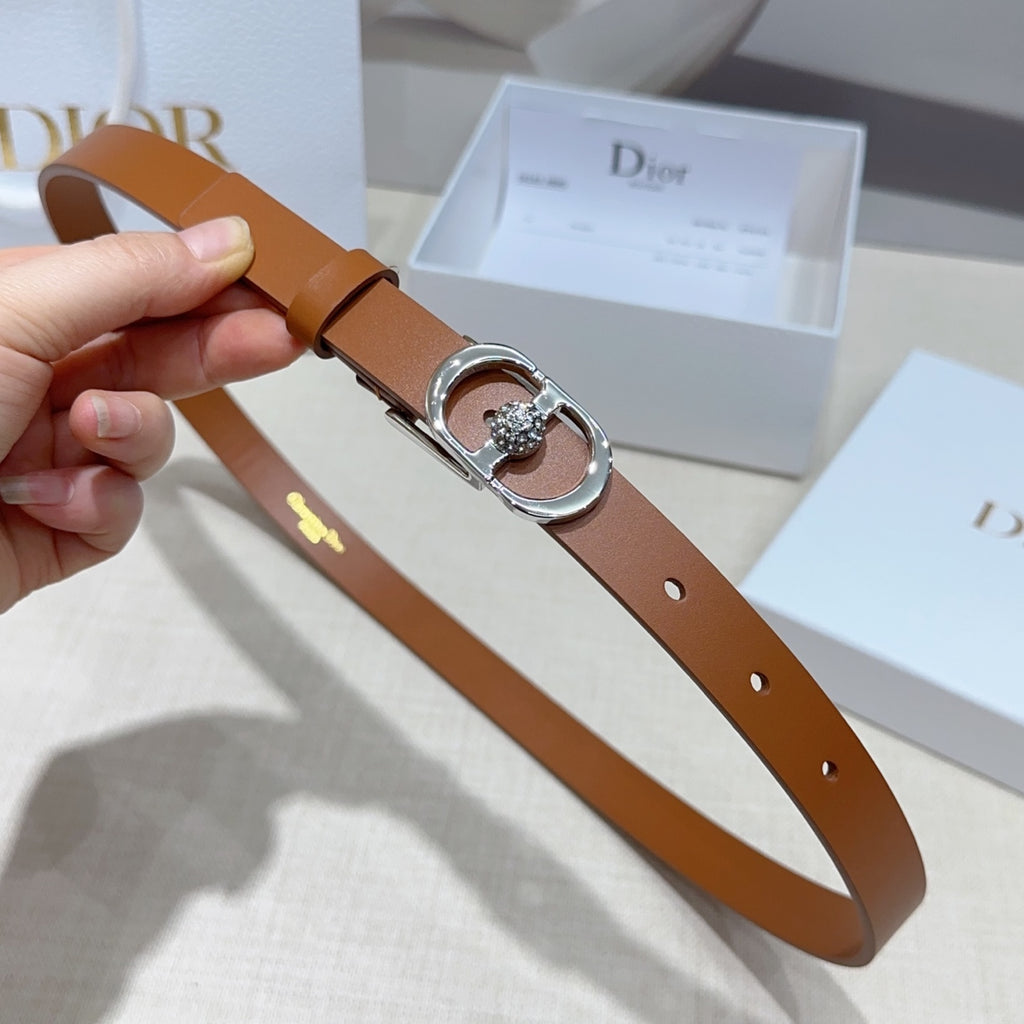Tan leather belt with silver buckle, crystal centerpiece, and belt holes