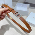 Tan leather belt with silver buckle, crystal centerpiece, and belt holes