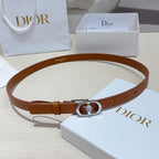 Tan leather belt with silver buckle and oval crystal detail, flat lay