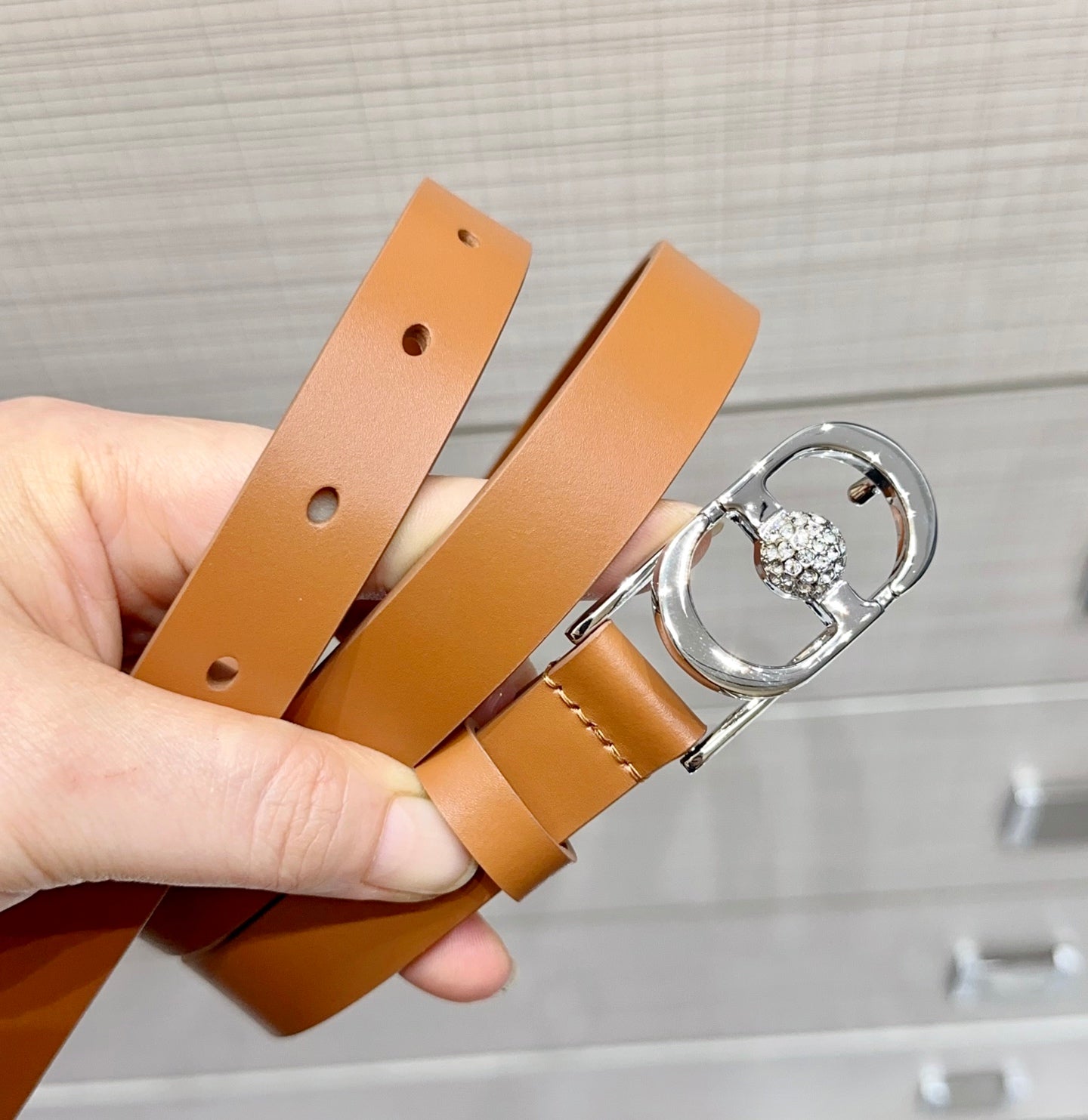 Tan leather belt with silver buckle and crystal O-ring charm