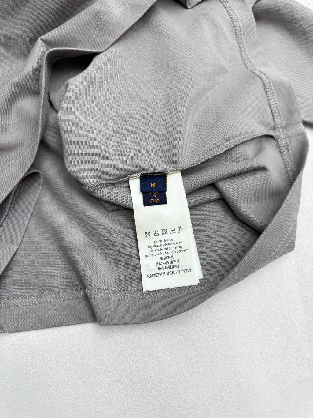 Light gray T-shirt with interior neck and care label visible