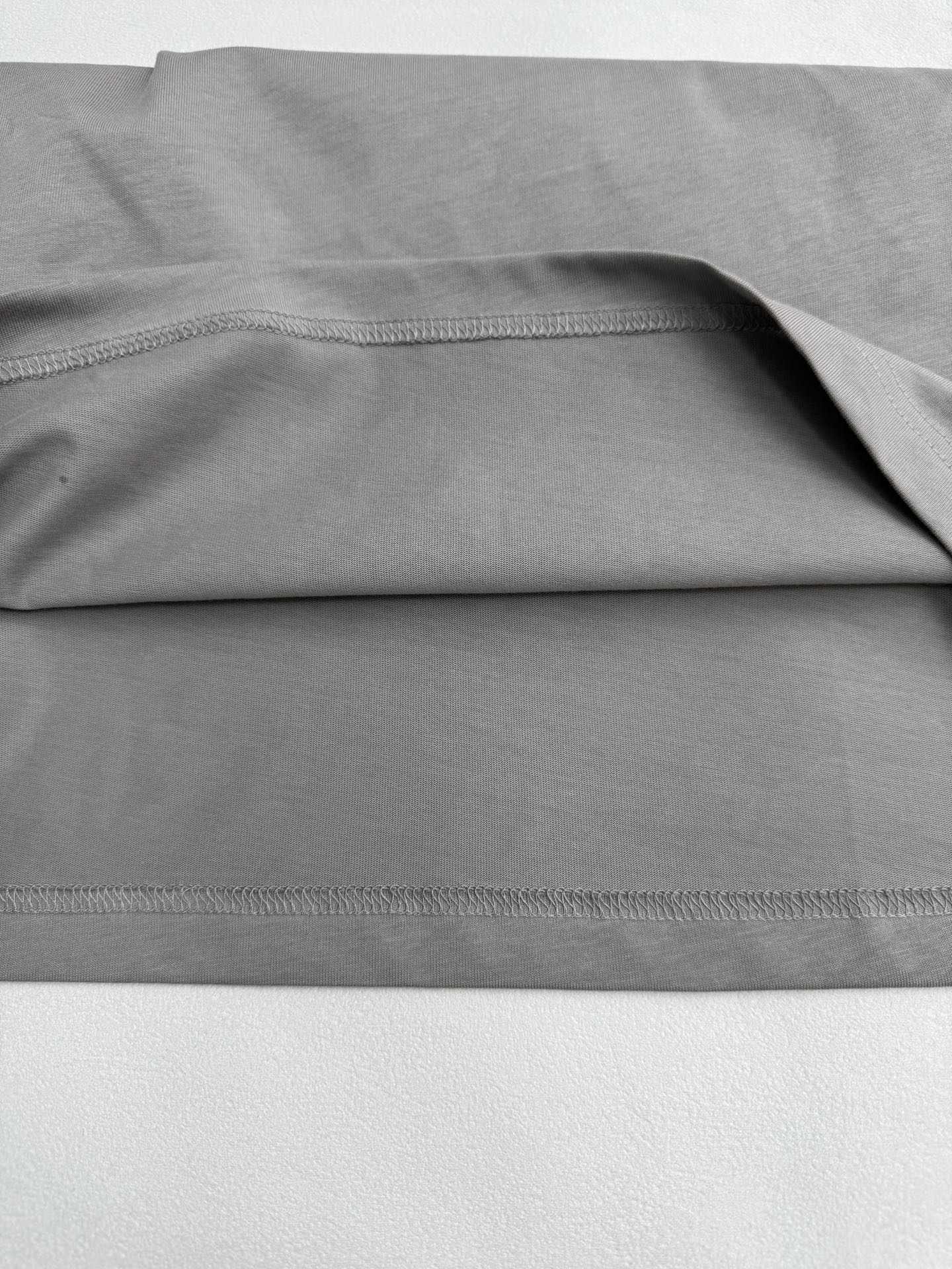 Light gray T-shirt fabric with stitched hem and side seam detail