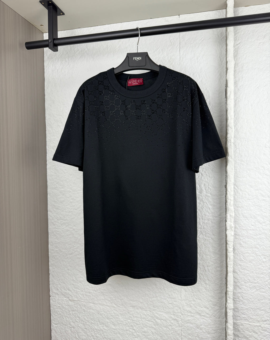 Black short-sleeve T-shirt with subtle logo pattern