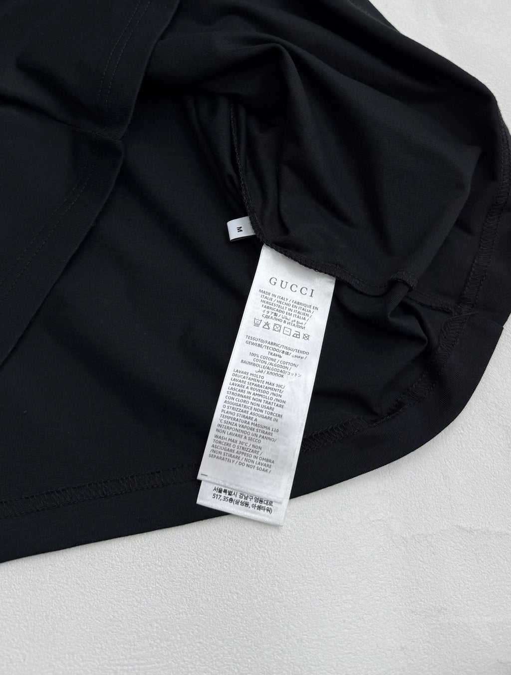 Black T-shirt with care label and inner neck tag