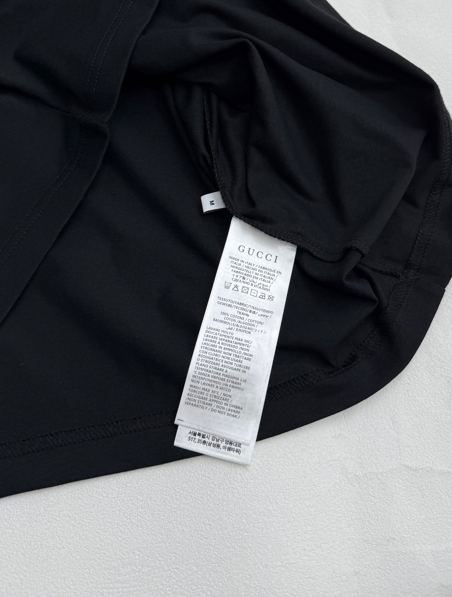 Black T-shirt with care label and inner neck tag